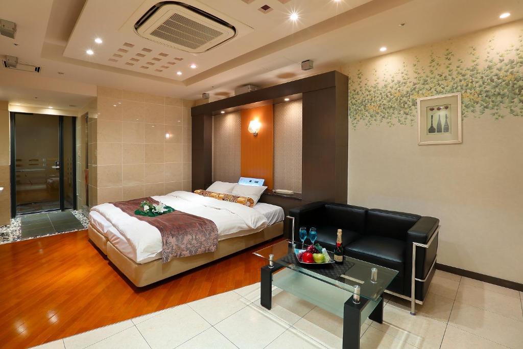 Ein Bett oder Betten in einem Zimmer der Unterkunft Hotel AXIS -アクシス-