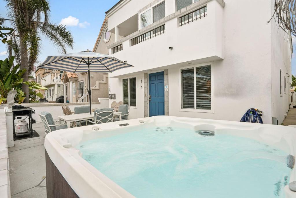 a hot tub in the backyard of a house at Stunning Beach Delight with Hot Tub, Fire Pit, Parking & Walk to Beach! in San Diego