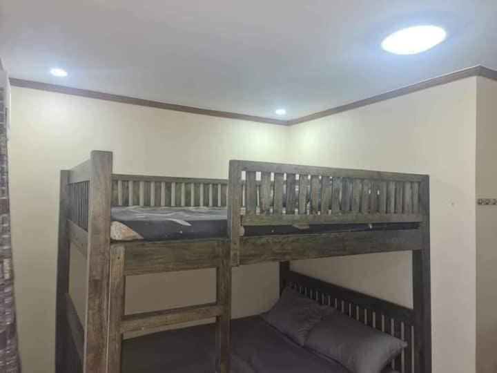 a bunk bed in the corner of a room at Dantes place in Lumban