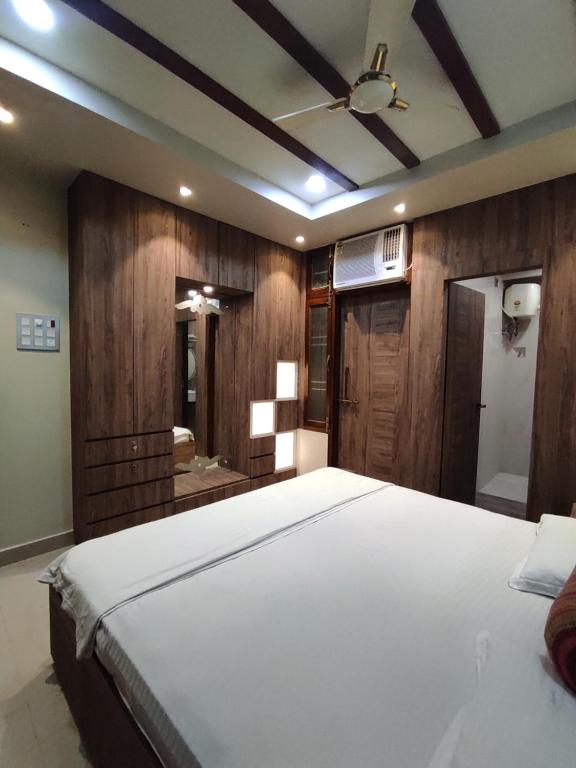 a bedroom with a large bed and a bathroom at Rudraksha Inn in Varanasi