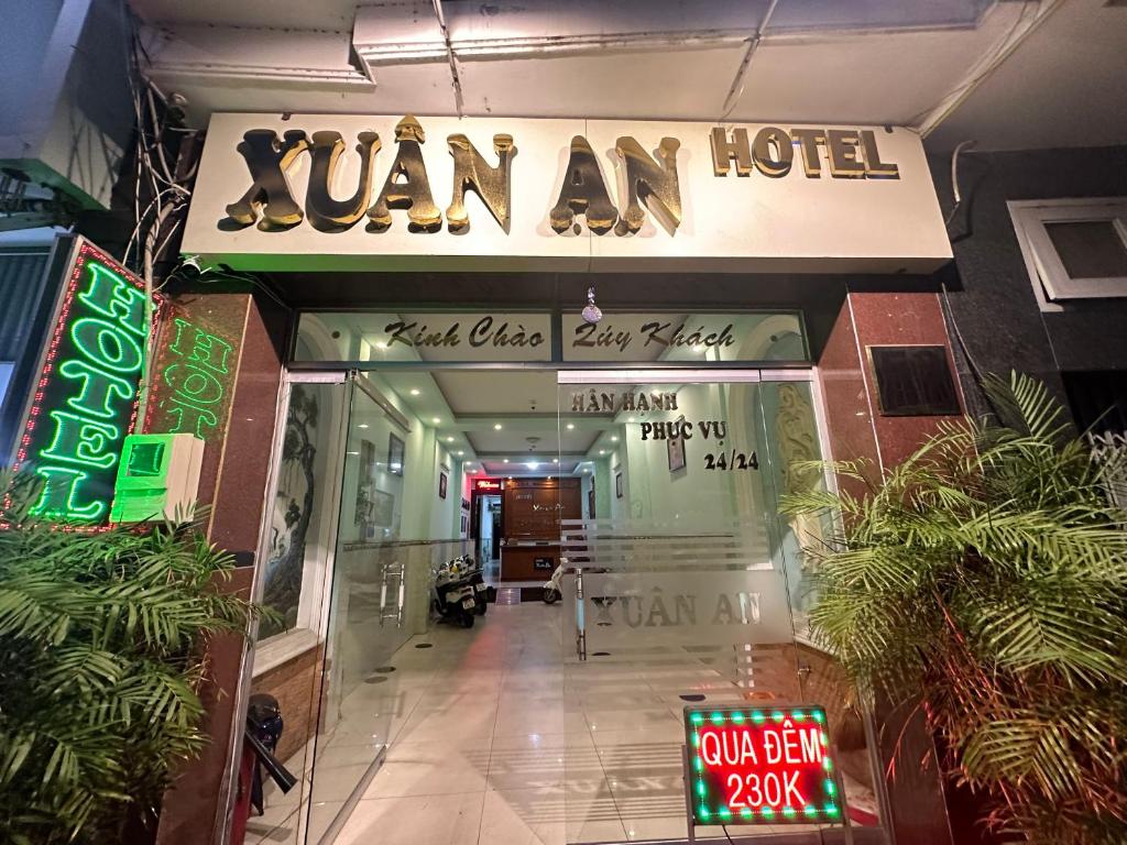 a building with a sign for a van am hotel at Xuân An Hotel - 53 Nguyễn Thái Bình, Q. Tân Bình - by Bay Luxury in Ho Chi Minh City