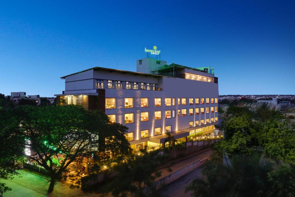 a large building with lights on at night at Lemon Tree Hotel, Hubli in Hubli