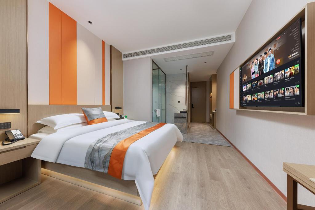 Postel nebo postele na pokoji v ubytování Guangzhou Yachen Hotel