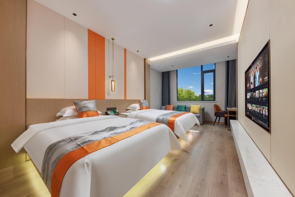 Postel nebo postele na pokoji v ubytování Guangzhou Yachen Hotel