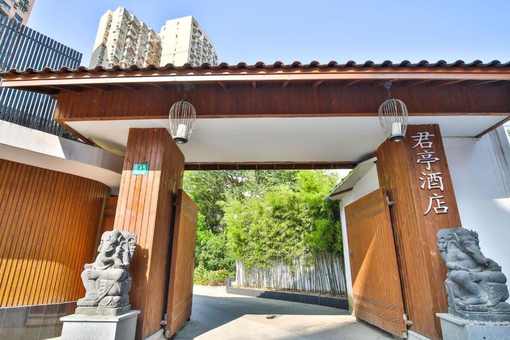 an entrance to a building with a gate withinese writing on it at SSAW Boutique Hotel Shanghai Yilin in Shanghai