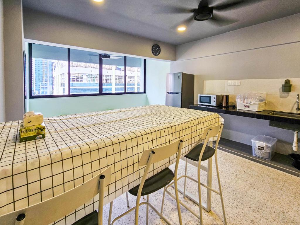 a kitchen with a table and two chairs in a room at Stay429 at Bukit Bintang 4bedroom 15pax By Shine Stay in Kuala Lumpur