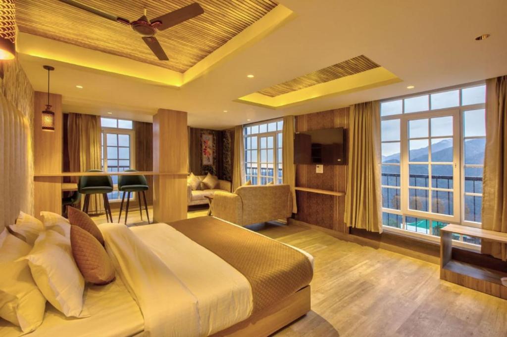 een slaapkamer met een groot bed en een woonkamer bij Hotel Katson Castle Dharamshala in McLeod Ganj