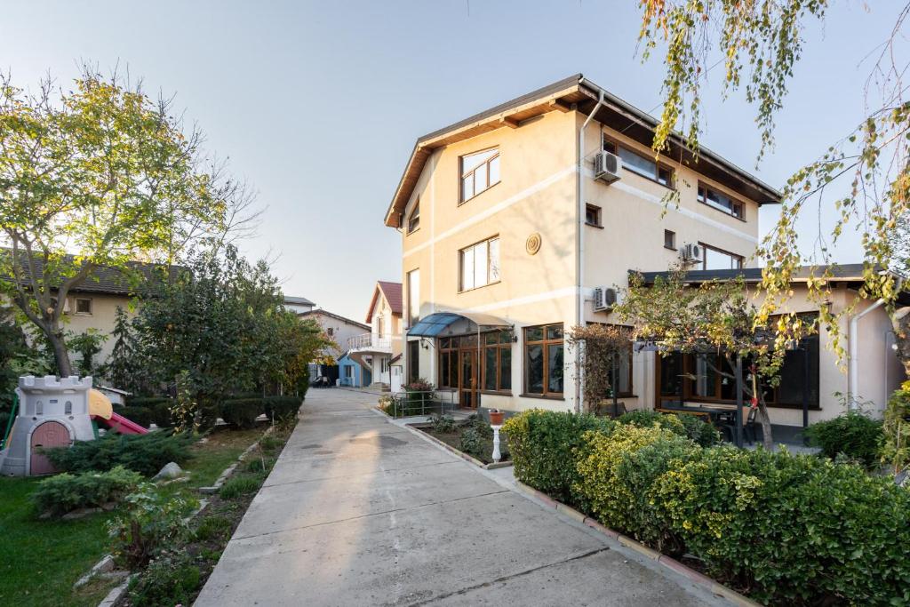 an empty street in front of a house at Cristalex Villaverde Bucharest in Bucharest