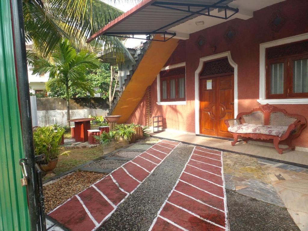 an open door of a house with a patio at Star Home Stay Bentota in Bentota