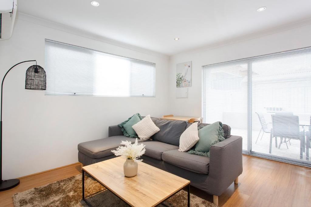 a living room with a couch and a table at Suburban Living - 2 bedroom apartment Victoria Park in Perth