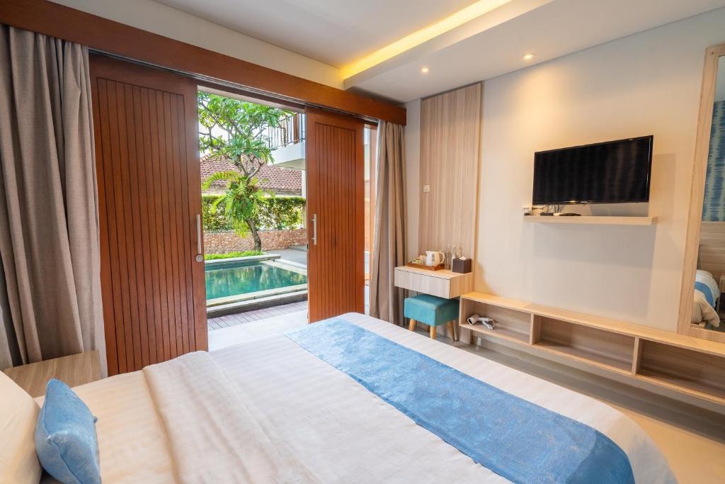 Postel nebo postele na pokoji v ubytování Mahesa Suites Seminyak