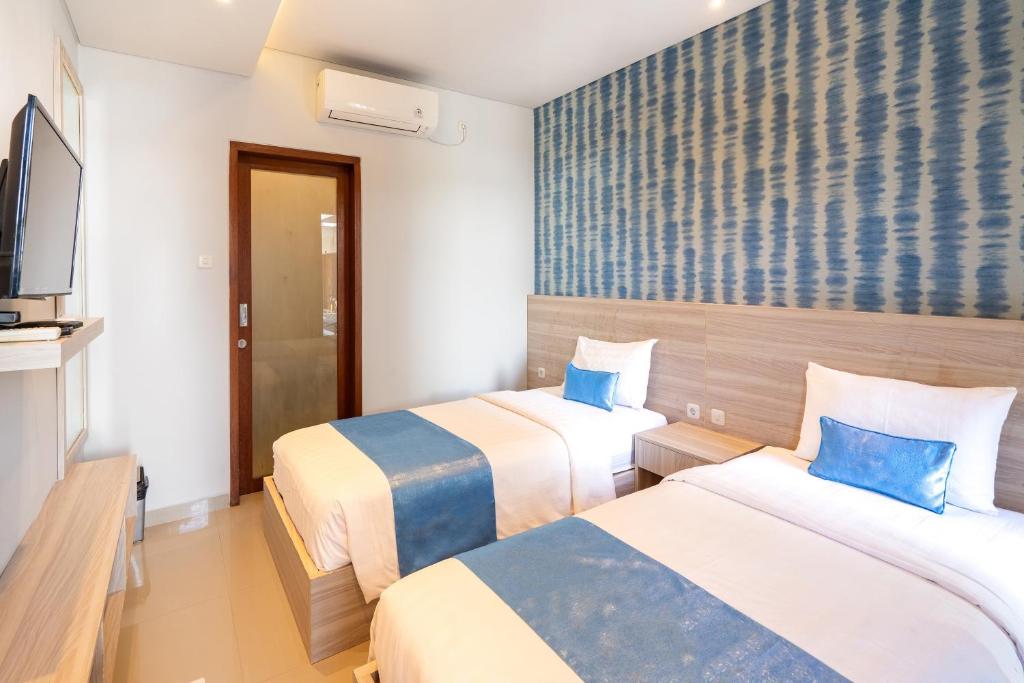 Postel nebo postele na pokoji v ubytování Mahesa Suites Seminyak