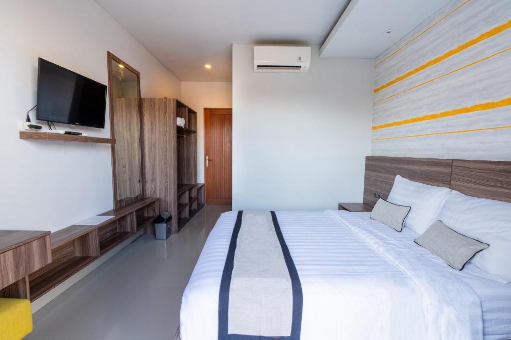 Postel nebo postele na pokoji v ubytování Mahesa Suites Seminyak