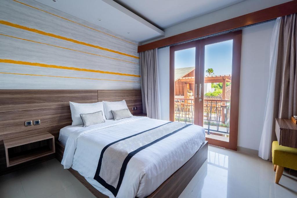 Postel nebo postele na pokoji v ubytování Mahesa Suites Seminyak