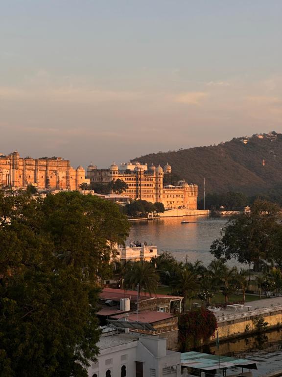 a view of a city with a body of water at The People Hostel in Udaipur