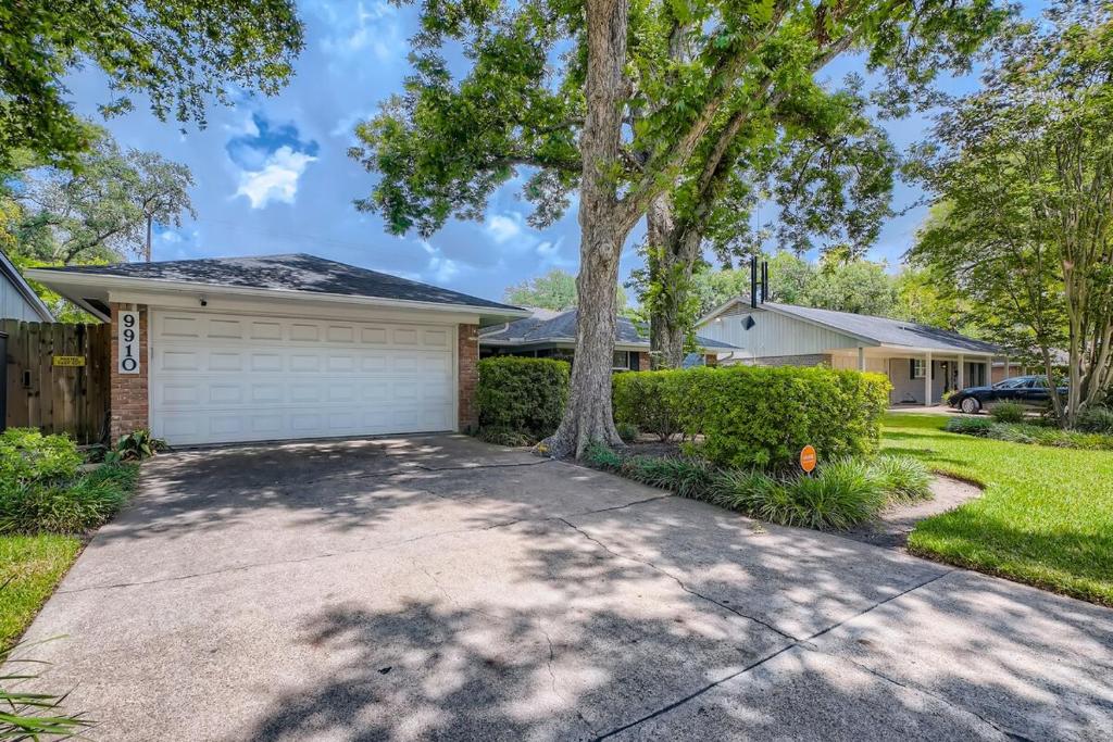 a house with a tree and a driveway at Exquisite 3x2 W Pool Oasis Near City Center in Houston