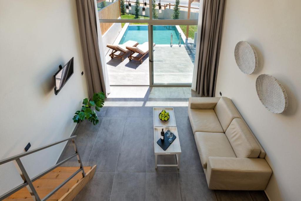 a living room with a couch and a table at Haraki Luxury Villas in Haraki