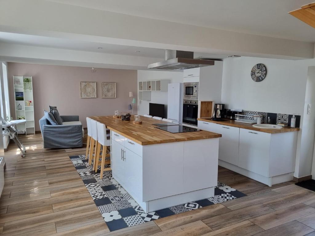 a kitchen with white cabinets and a counter top at Le clos Champlieu in Orrouy