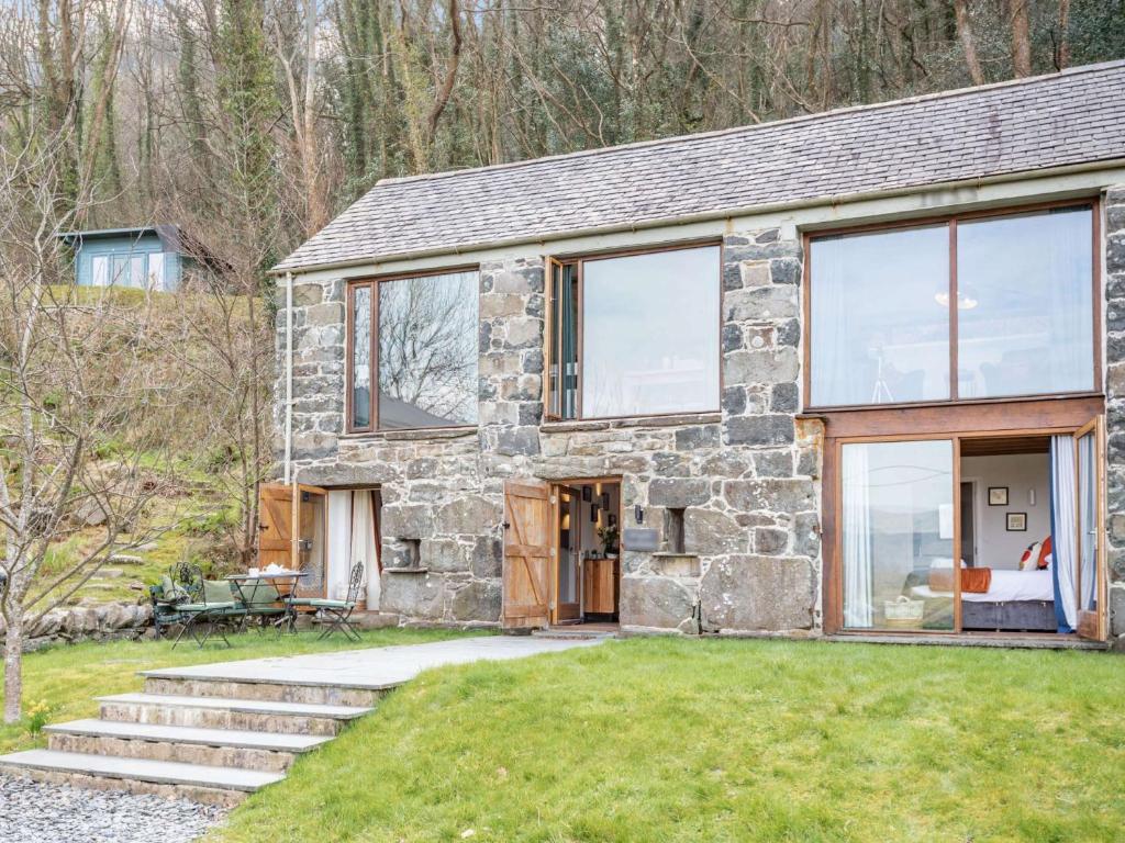 a stone house with glass doors and windows at 2 bed in Arthog 66611 in Arthog