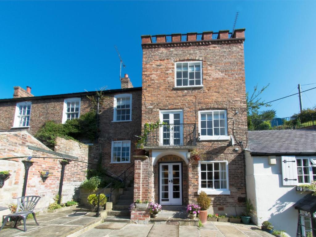 an old brick house with a white door at 4 bed property in Knaresborough HH090 in Knaresborough