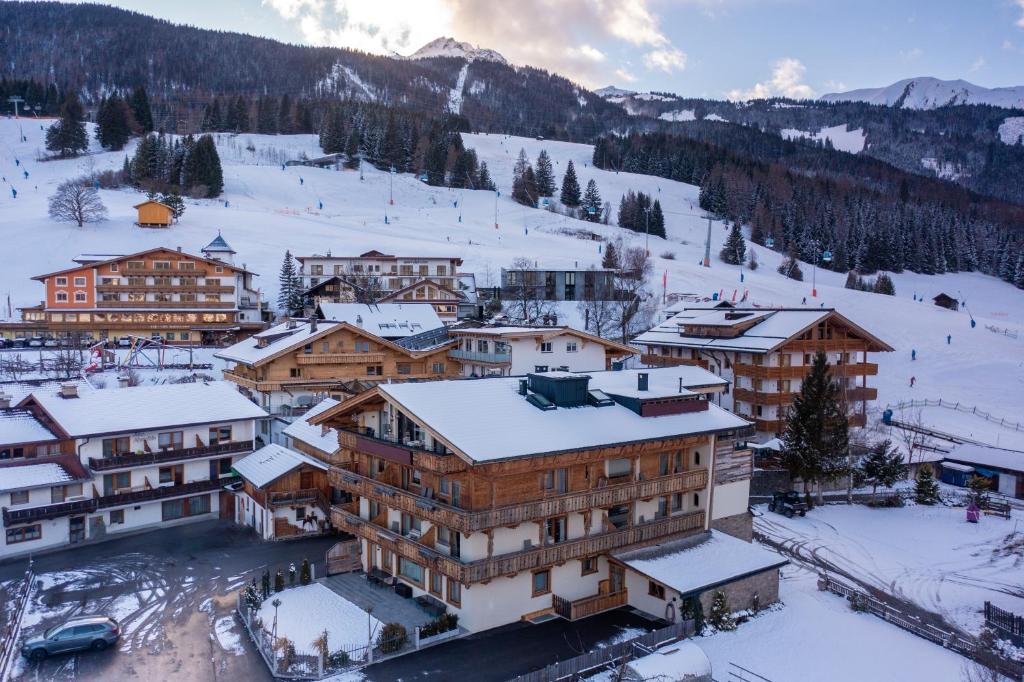 a group of buildings in the snow on a mountain at Zugspitz Suites Lermoos by ALPS RESORTS in Lermoos