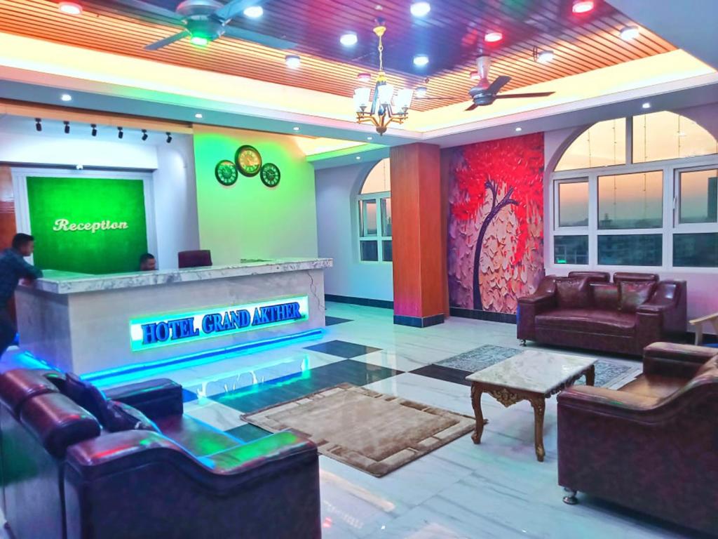 a living room with a tv and a bar at Hotel Grand Akther Sylhet in Sylhet