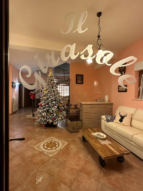 a living room with a christmas tree and a chandelier at B&B Il Girasole in Castel di Sangro