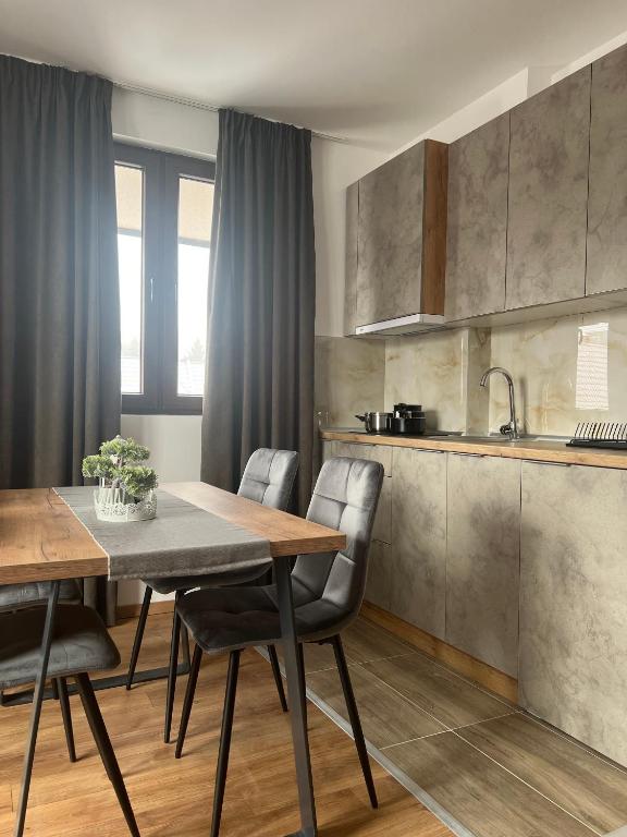 a kitchen and dining room with a table and chairs at Apartments SKY Kopaonik in Kopaonik