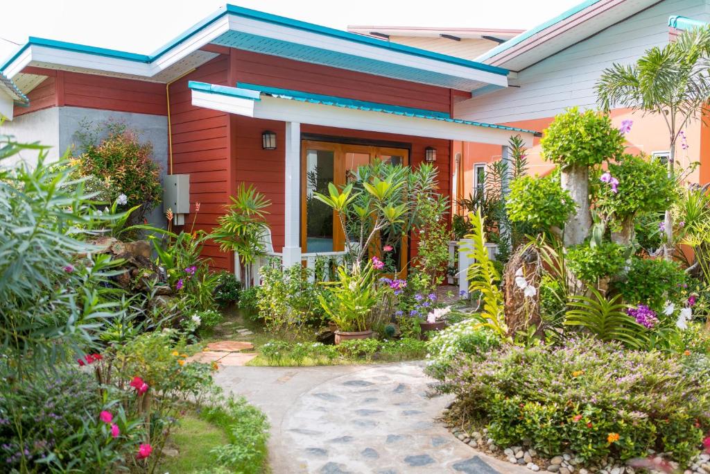 a house with a garden in front of it at Thai Smile Bungalows in Ko Lanta