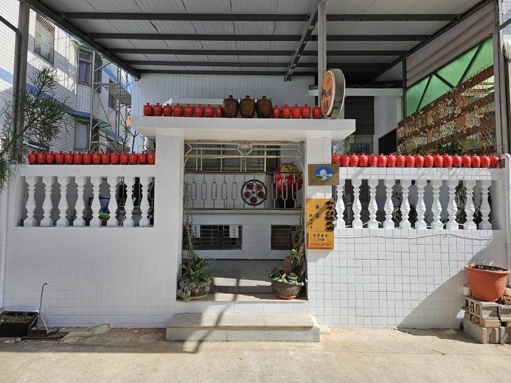 a building with a kitchen with red umbrellas at Peace 28 B&B in Jincheng