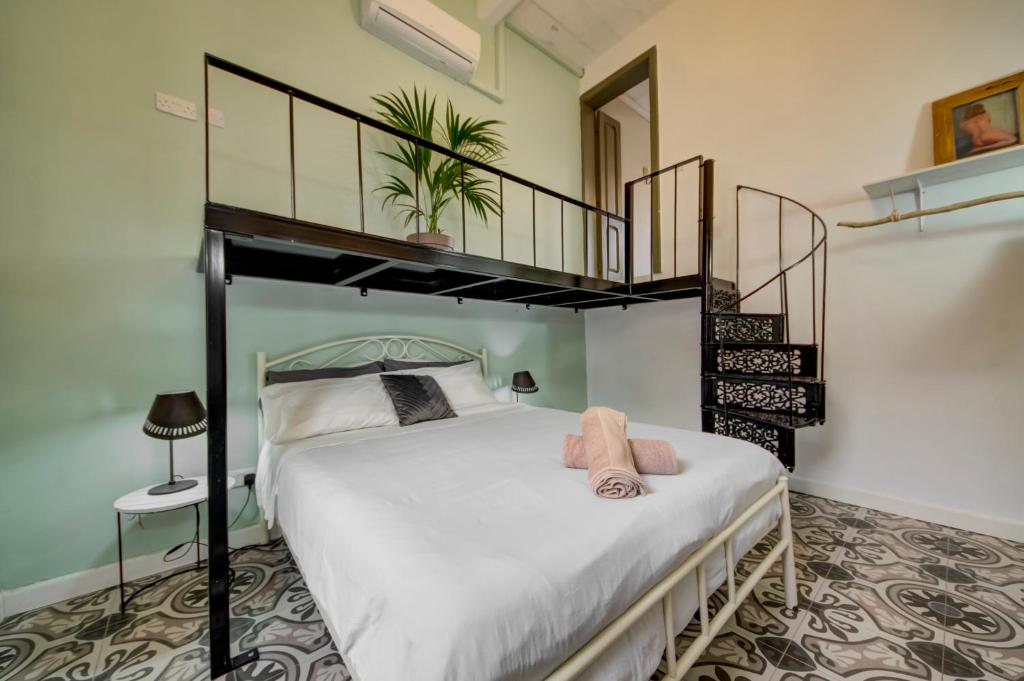 a bedroom with a bed with a loft bed at Boho Rooms Sliema in Sliema