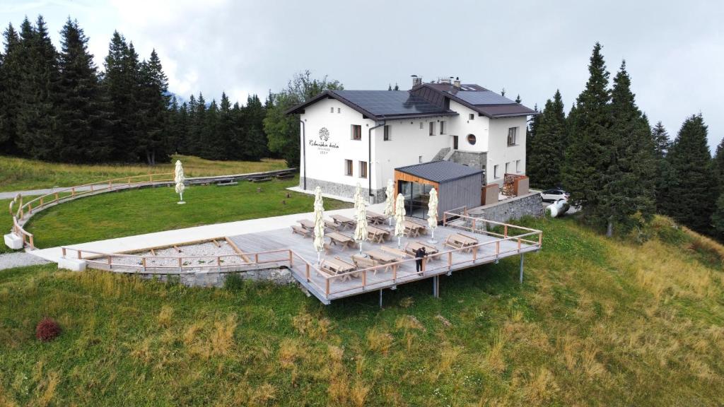 an aerial view of a house on a hill at Ribniška koča in Ribnica na Pohorju