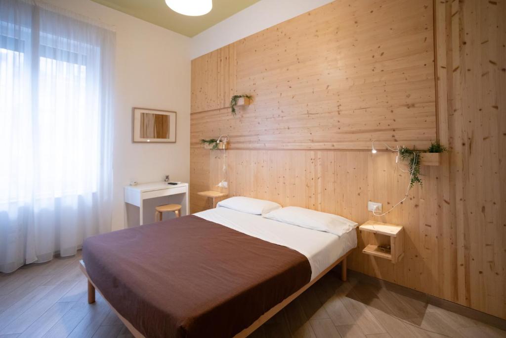 a bedroom with a bed and a wooden wall at B&B In Natura in Salerno