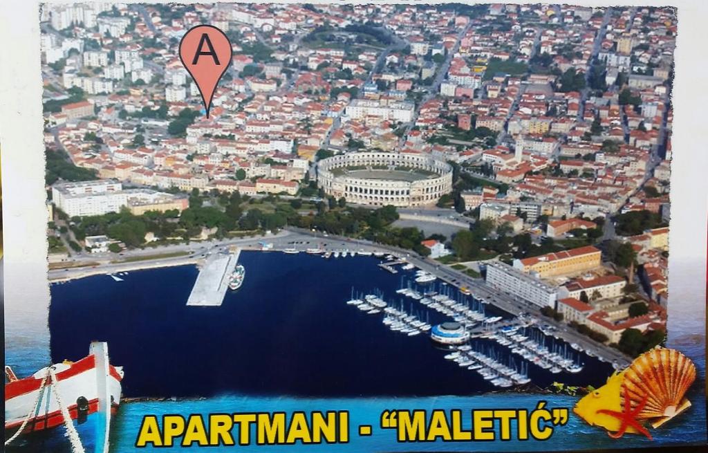 an aerial view of a marina with a kite in the air at Apartments Maletic in Pula