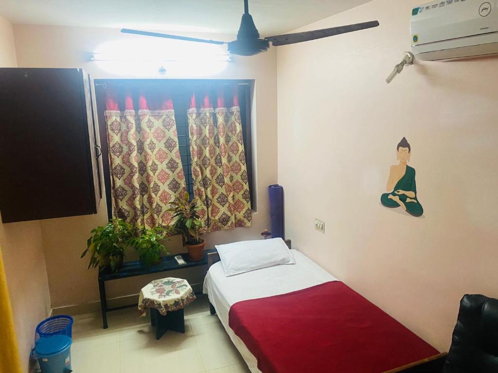 a bedroom with a bed and a painting on the wall at Homestay - Heaven Aumgarden in Trivandrum