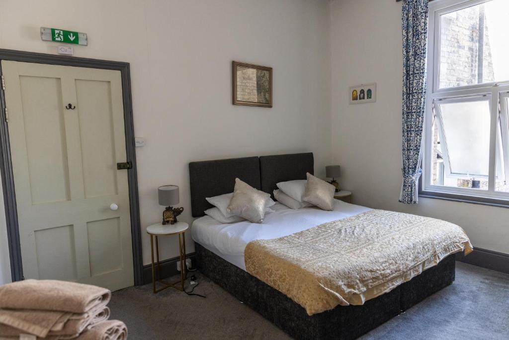 a bedroom with a bed and a door and a window at CloudZen in Kent