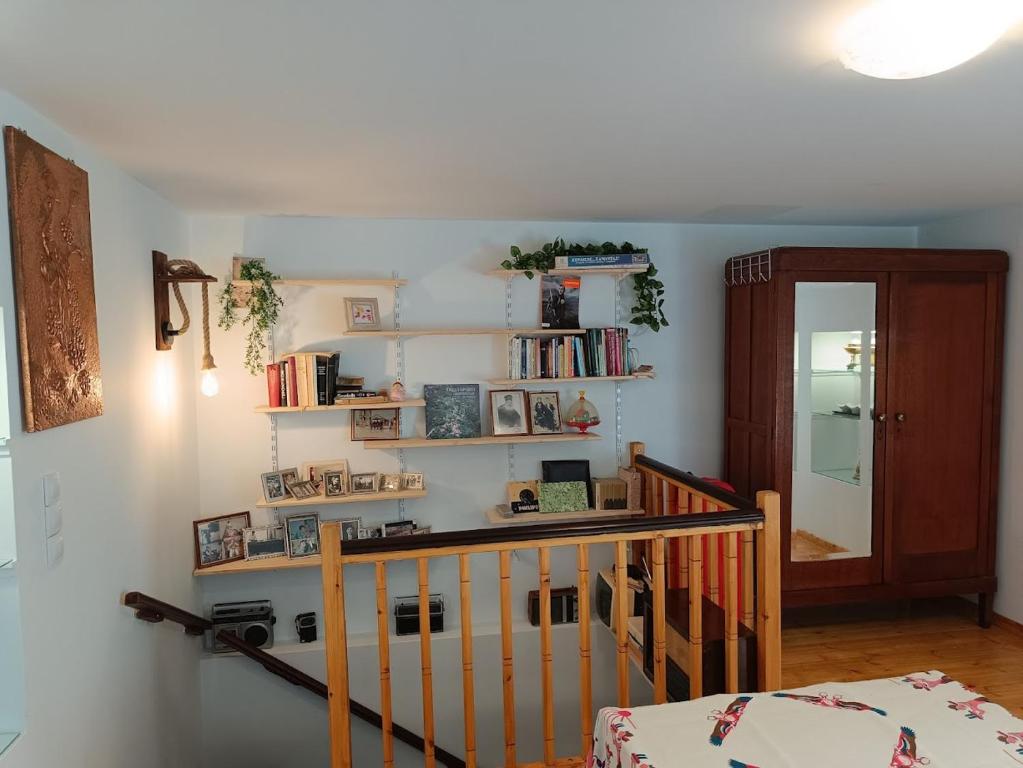 a room with a crib and shelves with books at Charlami's Mansion -Παραδοσιακό Πέτρινο Σπίτι με Τζάκι και Πανοραμική Θέα in Polýdroson