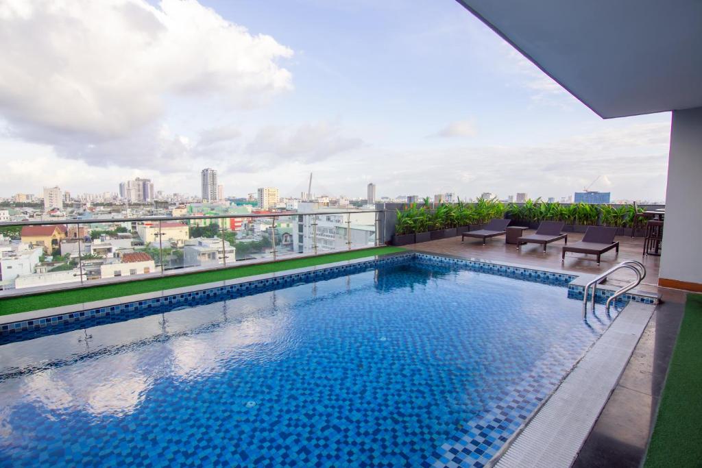 a swimming pool on the roof of a building with a view at Quoc Cuong Center Da Nang Hotel by Haviland in Danang