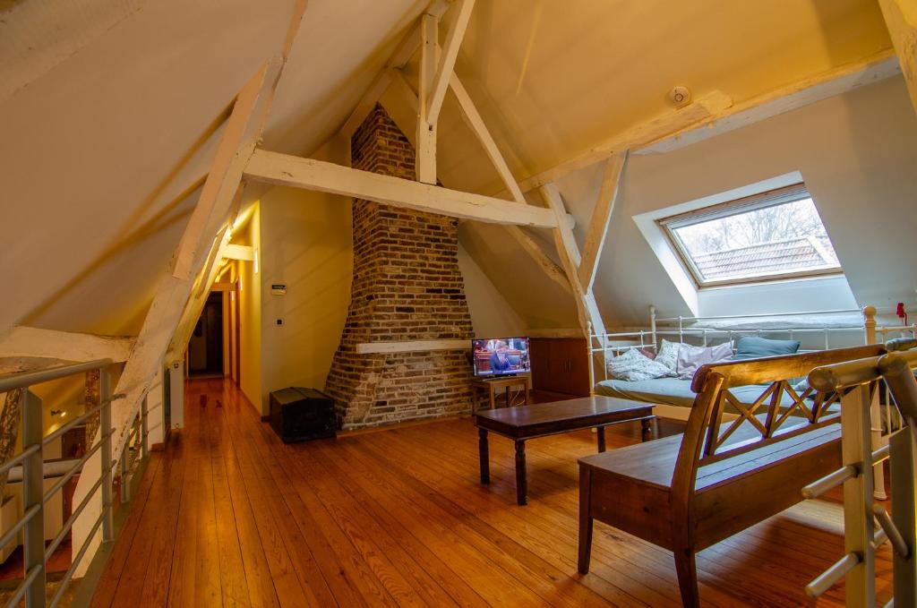 a living room with a loft with a brick wall at Vakantiewoning De Luysmolen in Bocholt