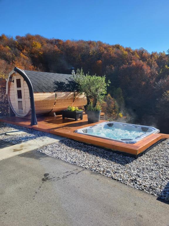 a hot tub sitting on the side of a house at Resort TimAJA - pool, massage pool, sauna in Trebnje