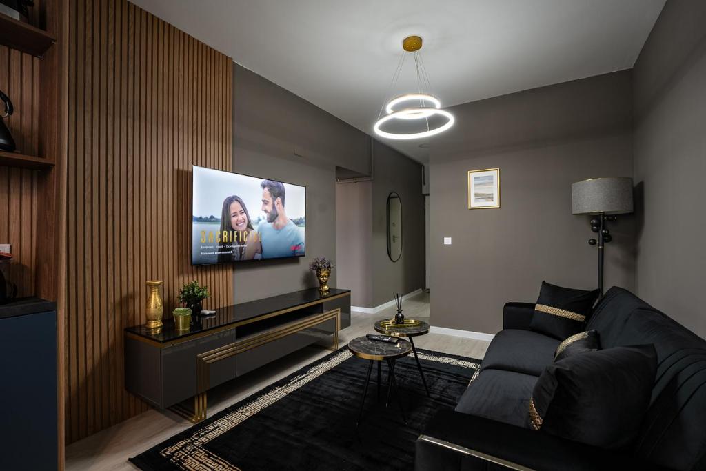 a living room with a couch and a flat screen tv at Blvd Ivory Pipera ap.62B in Bucharest