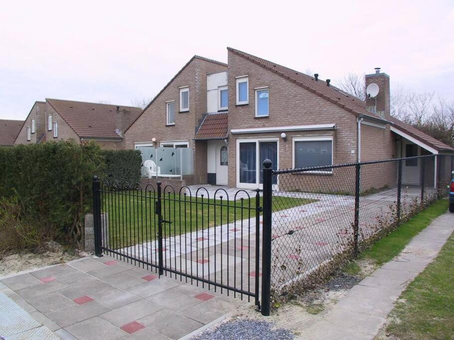 a black fence in front of a house at Crox Houcke 65 in Nieuwvliet