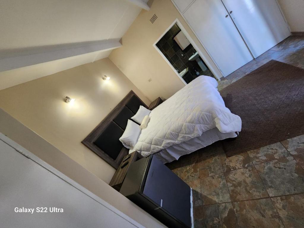 an overhead view of a bed in a room at WAMPEX GUEST HOUSE IN RUSTENBURG in Rustenburg