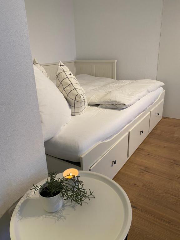 a bedroom with a bed and a table with a plant on it at Ferienwohnung am See im Fichtelgebirge in Nagel