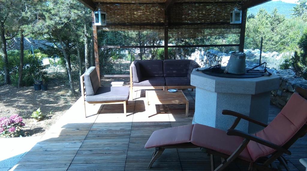 a patio with chairs and a table and a fireplace at Apartment Tasha in Ist