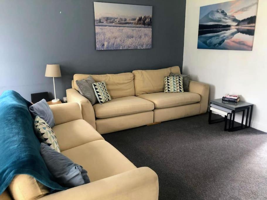 a living room with a couch and a table at Aspen House in Birmingham