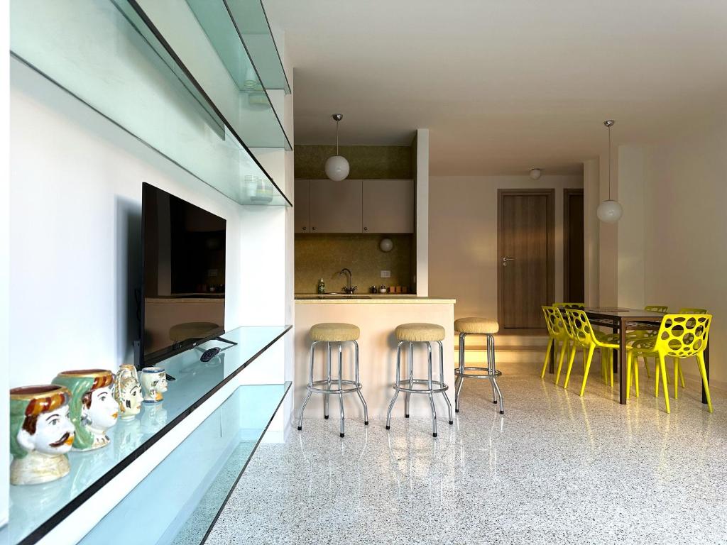 a kitchen with yellow chairs and a table in a room at Apartments Navigli in Milan