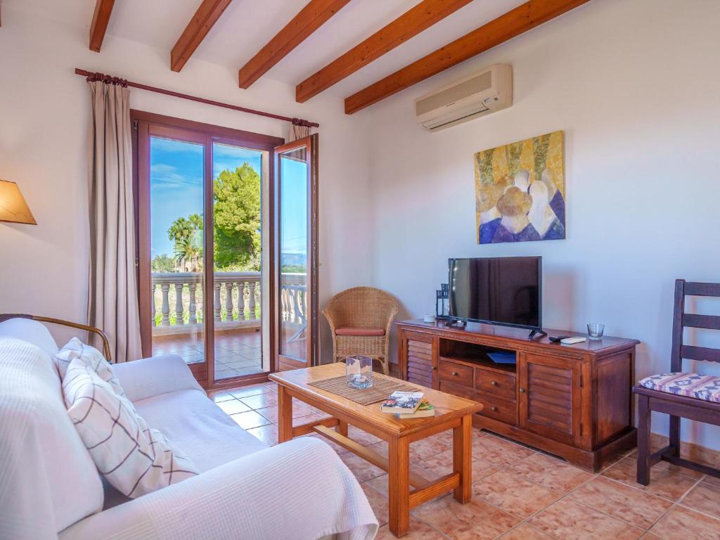 A television and/or entertainment centre at Apartment Finca Can Corritx-1 by Interhome