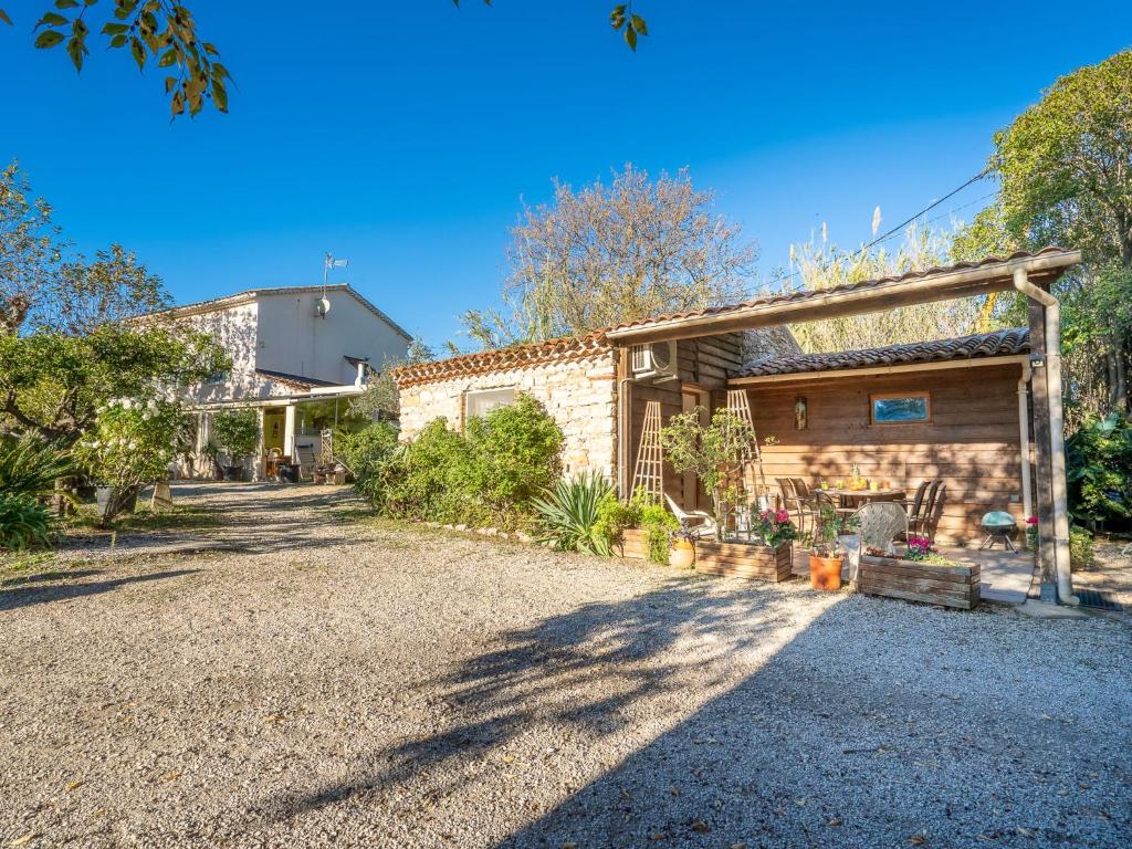 a house with a gravel driveway in front of it at Holiday Home Magali - HYE550 by Interhome in Hyères