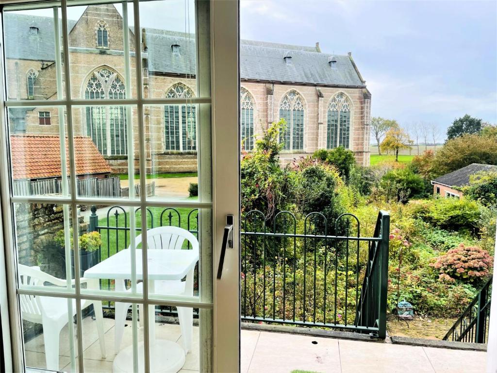 a view from a window of a church at Holiday Home Dijkhuisje by Interhome in Brouwershaven